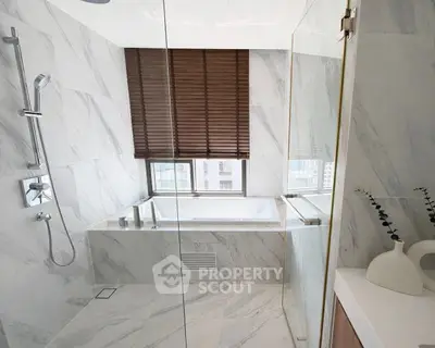 Luxurious bathroom with marble finishes and large bathtub in modern apartment