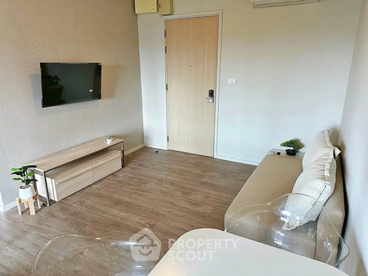 Modern living room with minimalist decor and wall-mounted TV