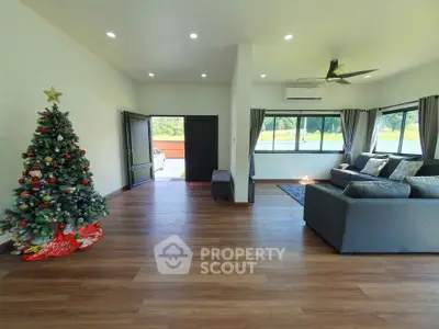 Spacious living room with Christmas tree and modern decor