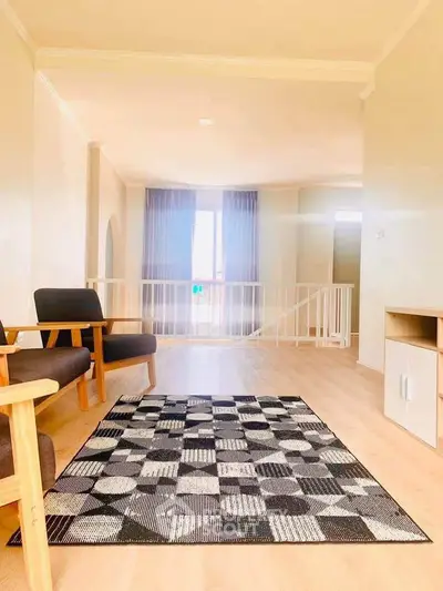 Spacious living room with modern furniture and natural light, perfect for relaxation and entertainment.