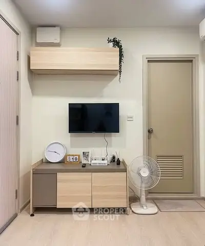 Modern living room with wall-mounted TV and stylish storage unit
