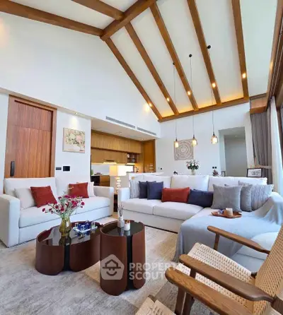 Luxurious living room with high ceilings and modern decor, featuring cozy seating and elegant lighting.