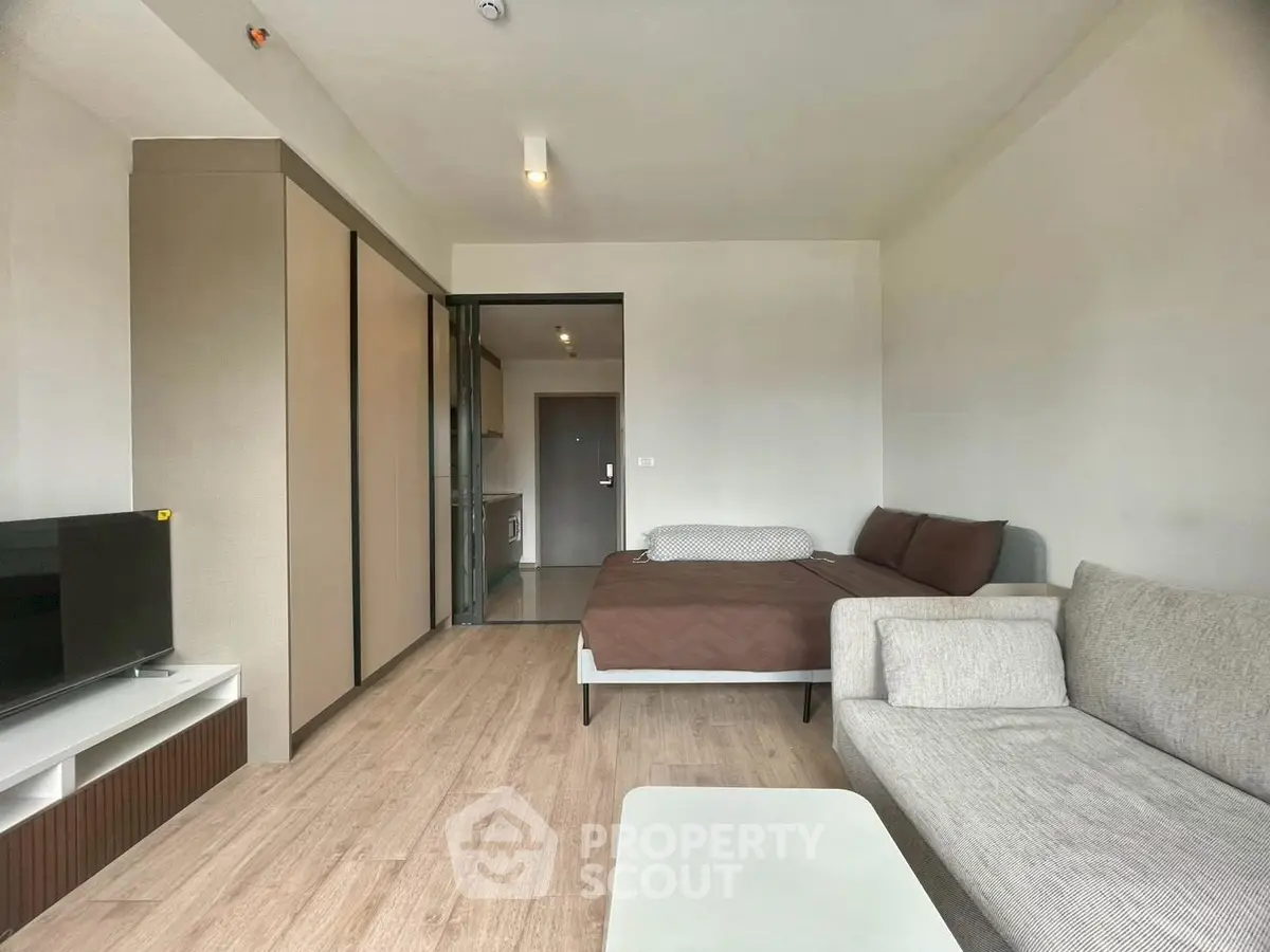 Modern studio apartment with cozy living area and sleek design