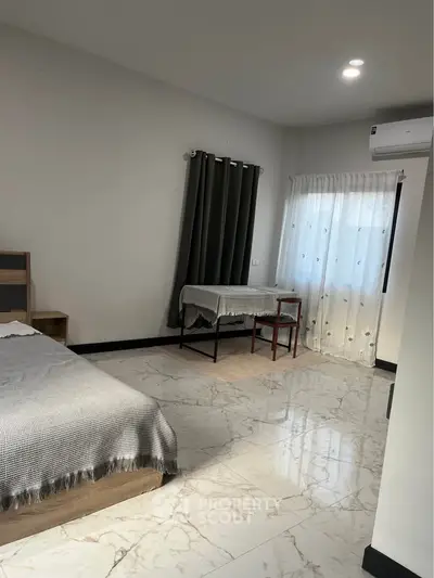 Spacious bedroom with modern decor and natural light