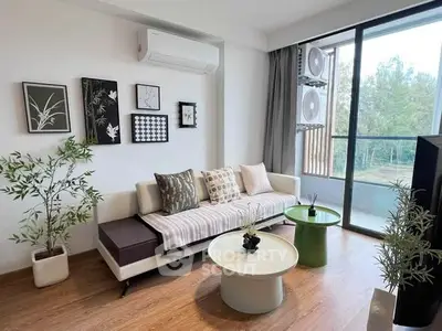 Modern living room with stylish decor and balcony view, featuring sleek furniture and natural light.
