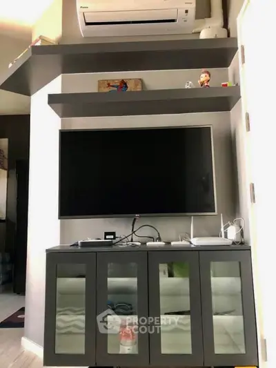 Modern living room with sleek TV unit and air conditioning, perfect for comfortable living.