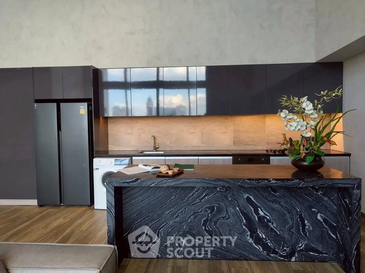 Luxurious modern kitchen with sleek black marble island and high-end appliances