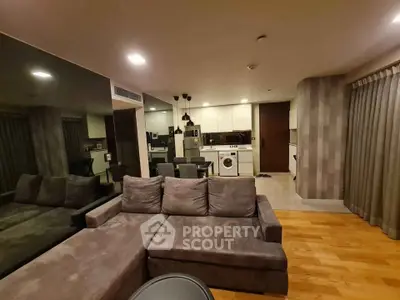 Spacious modern living room with open kitchen and cozy seating area, perfect for entertaining.
