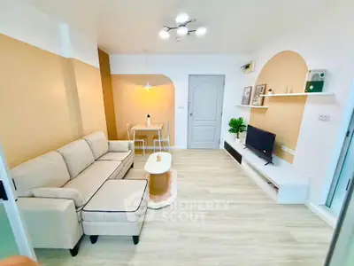 Modern living room with stylish decor, cozy sofa, and sleek TV setup in a bright apartment.