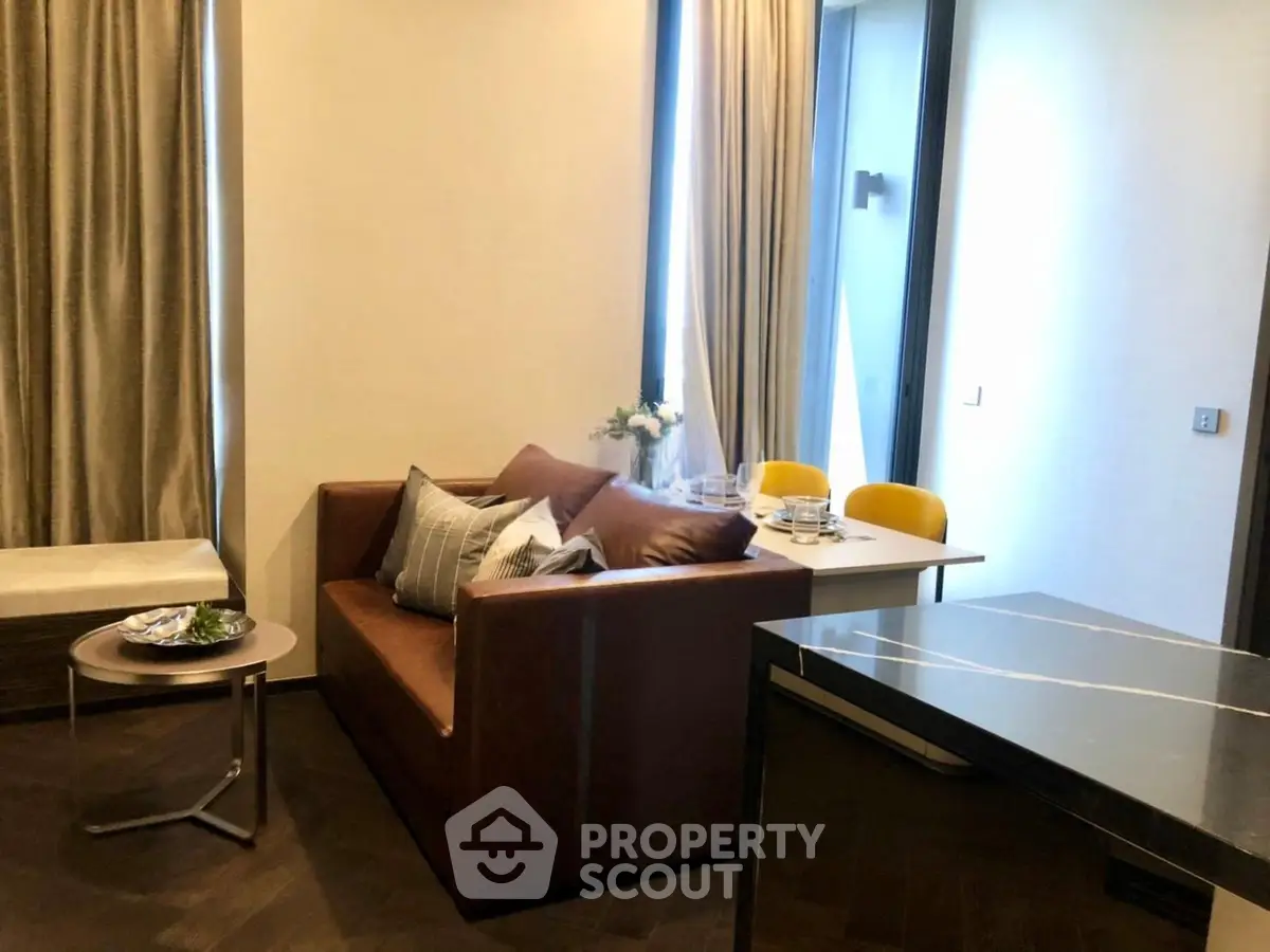 Modern living room with stylish sofa and dining area in a cozy apartment setting.