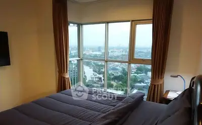 Stunning bedroom with panoramic city view from large windows, perfect for urban living.