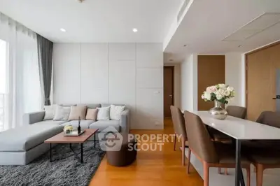 Modern living room with stylish decor and cozy seating area in a bright apartment.