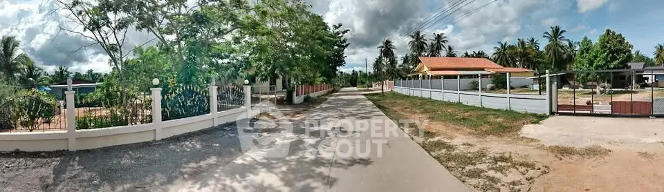 Charming suburban street with lush greenery and spacious homes, ideal for tranquil living.