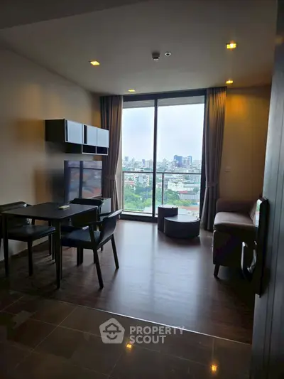 Modern living room with city view, sleek furniture, and large windows in a high-rise apartment.