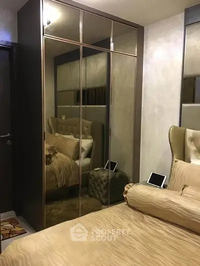 Luxurious bedroom with mirrored wardrobe and elegant bedding