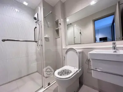 Modern bathroom with glass shower and sleek fixtures