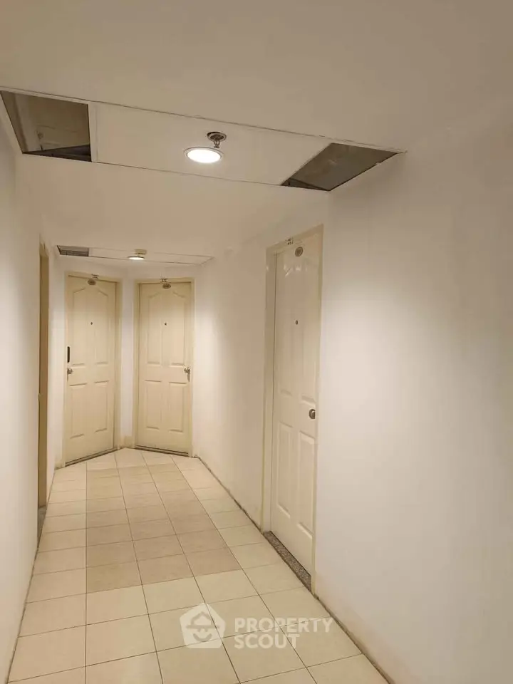 Bright hallway with multiple doors in a residential building
