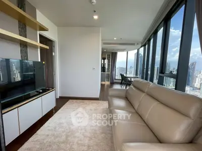 Luxurious high-rise living room with stunning city views and modern furnishings.