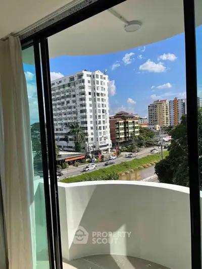 Spacious balcony with city view in modern apartment building