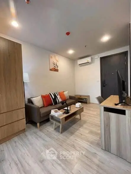 Modern living room with stylish decor and cozy ambiance, featuring a comfortable sofa and sleek wooden furniture.