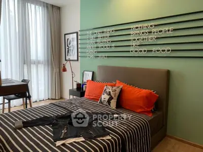 Stylish bedroom with modern decor and large window for natural light.