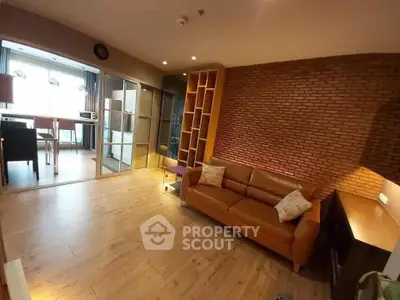 Spacious living room with brick accent wall and modern furnishings