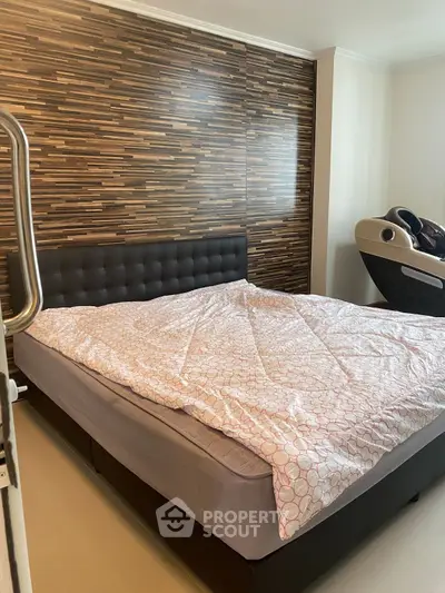 Modern bedroom with stylish wood accent wall and cozy bedding