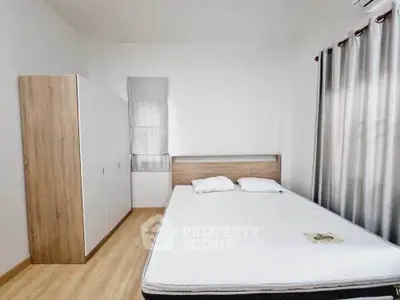 Spacious bedroom with modern furnishings and natural light