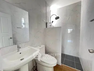 Modern bathroom with sleek fixtures and marble tiles