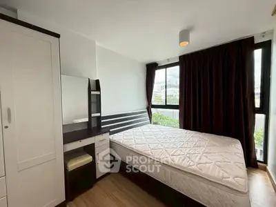 Cozy bedroom with large windows and modern furniture, perfect for relaxation and comfort.