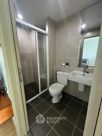 Modern bathroom with glass shower and sleek tile design