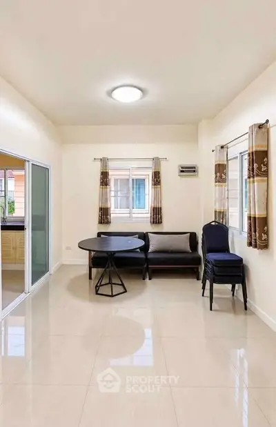 Spacious living room with modern furniture and large windows for natural light.