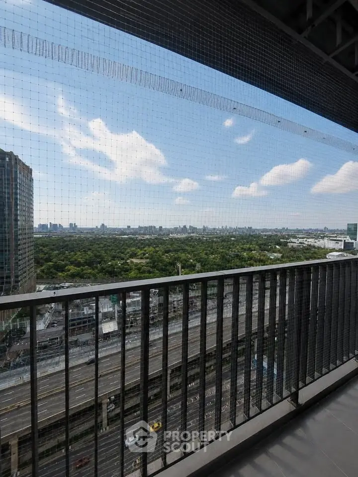 Stunning balcony view overlooking cityscape and lush greenery, perfect for urban living.