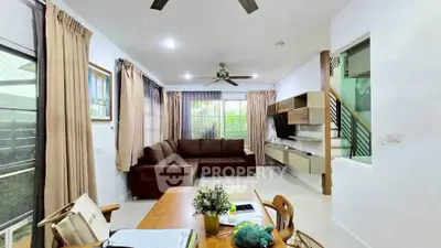 Spacious living room with modern decor and large windows for natural light.