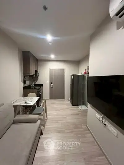 Modern apartment interior with cozy living area and compact kitchen