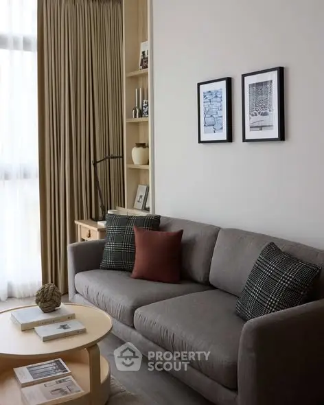 Stylish living room with modern sofa, elegant decor, and natural light, perfect for cozy relaxation.