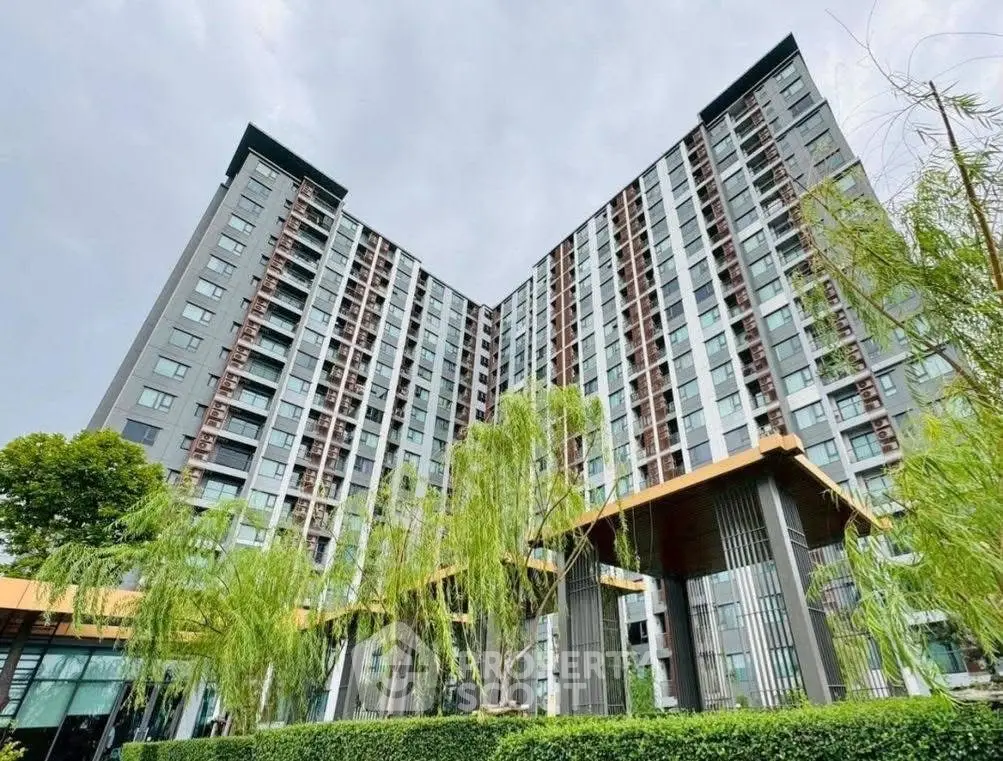 Modern high-rise building with lush greenery and sleek architecture
