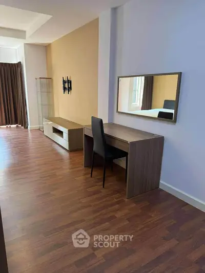 Spacious modern living room with wooden flooring and stylish furniture