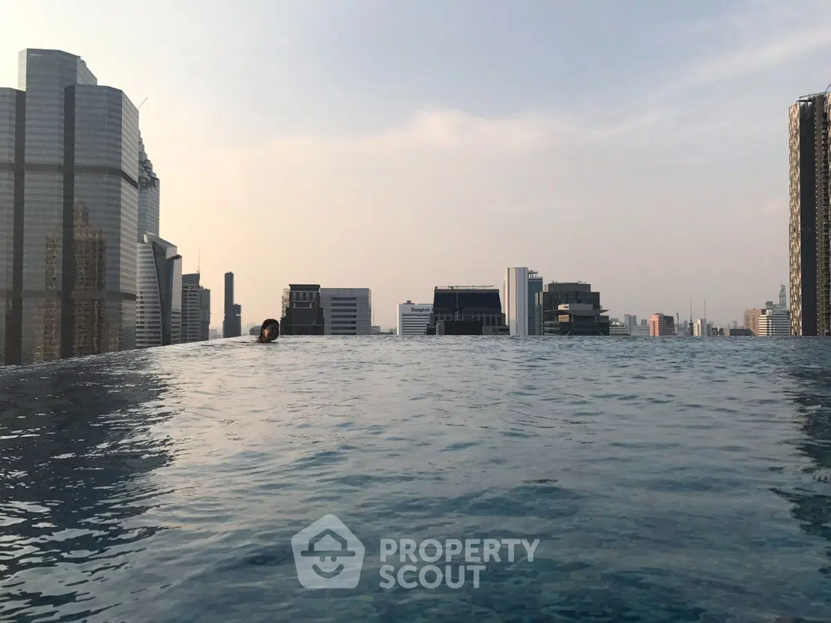 Stunning rooftop infinity pool with breathtaking city skyline view.