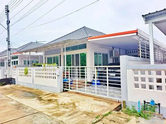 Charming single-story house with modern design and spacious driveway in a serene neighborhood.