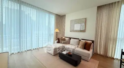 Luxurious living room with elegant decor and floor-to-ceiling windows in modern apartment.