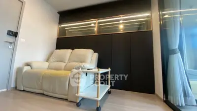 Modern living room with sleek black cabinets and cozy beige sofa