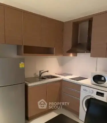 Modern kitchen with sleek cabinets, stainless steel appliances, and compact layout.