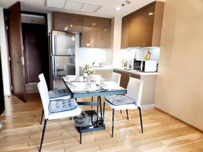 Modern kitchen with dining area, sleek cabinets, and stainless steel appliances