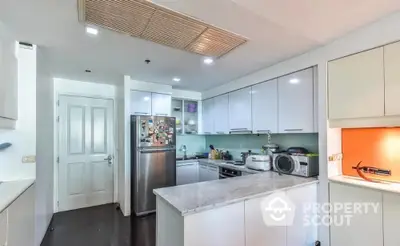 Modern kitchen with sleek white cabinets and marble countertop