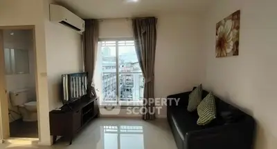 Modern living room with city view, sleek furniture, and natural light.