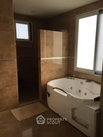 Luxurious bathroom with modern jacuzzi tub and elegant tile design