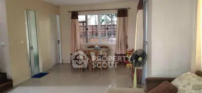 Spacious living room with modern decor and large window for natural light.
