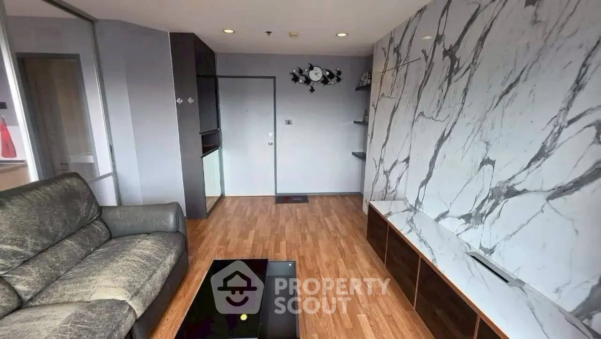 Modern living room with marble accent wall and sleek furniture