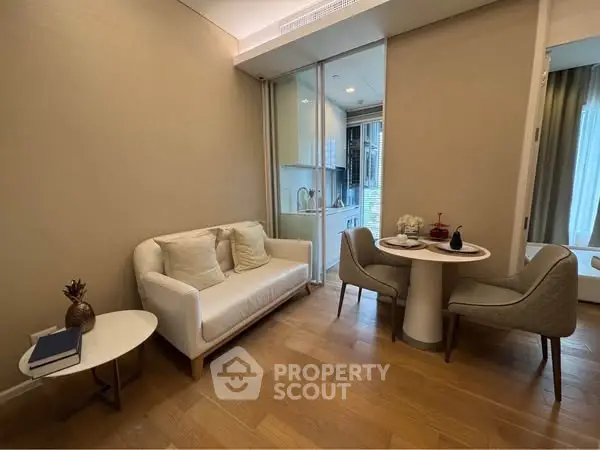 Cozy living room with modern decor and dining area in open layout apartment.